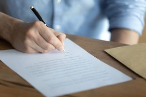 hand signing character letter for Michigan criminal defense court submission