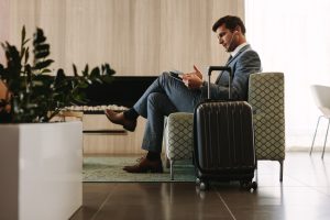 Business traveler reviewing court paperwork, travel documents, or pretrial release order.